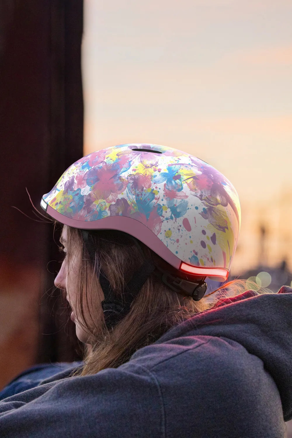 Girl at sunset wearing Lumos Nyxel Kids in Blossom with the rear light on